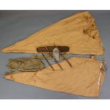 An early 20th century canvas one-man tent with bamboo poles.