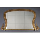 An early 20th century giltwood frame rectangular overmantel mirror on ceramic bun feet, 43½” wide