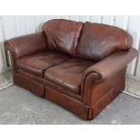 A tan leather three-piece lounge suite comprising of a two-seater settee, 59” long, & a pair of