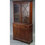 A reproduction mahogany tall standing bookcase, the upper part with three adjustable shelves