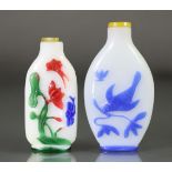 A Chinese overlay glass snuff bottle, with carved decoration to the green, red, pink, & blue overlay