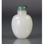 A Chinese pale celadon jade snuff bottle of compressed ovoid form, the stone of a pale greenish-
