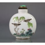 A Chinese porcelain famille rose decorated snuff bottle, of rounded form, with birds perched above
