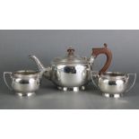 A silver three-piece tea service of plain round form with gadrooned borders, Birmingham 1926 by