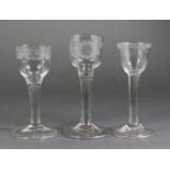 Three 18th century drinking glasses, the first with floral-engraved ogee bowl, 5¾”; the other two