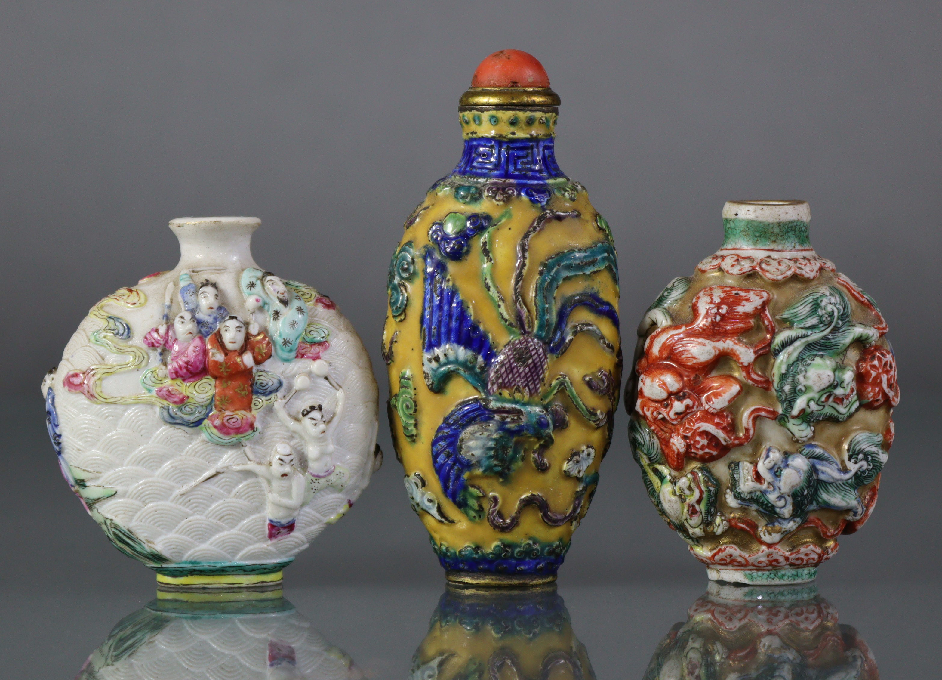 Three Chinese moulded porcelain snuff bottles, the largest decorated with a dragon & phoenix in - Image 2 of 5