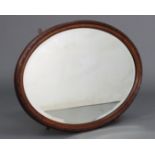 A mahogany frame oval wall mirror with moulded decoration, inset bevelled plate, 20½” wide x 29½”