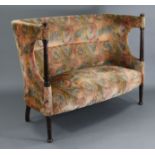 A late 19th/early 20th century wing-back settee, upholstered Art Nouveau style multicoloured