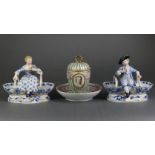 A pair of late 19th century Meissen male & female costume figure salts, each seated between two