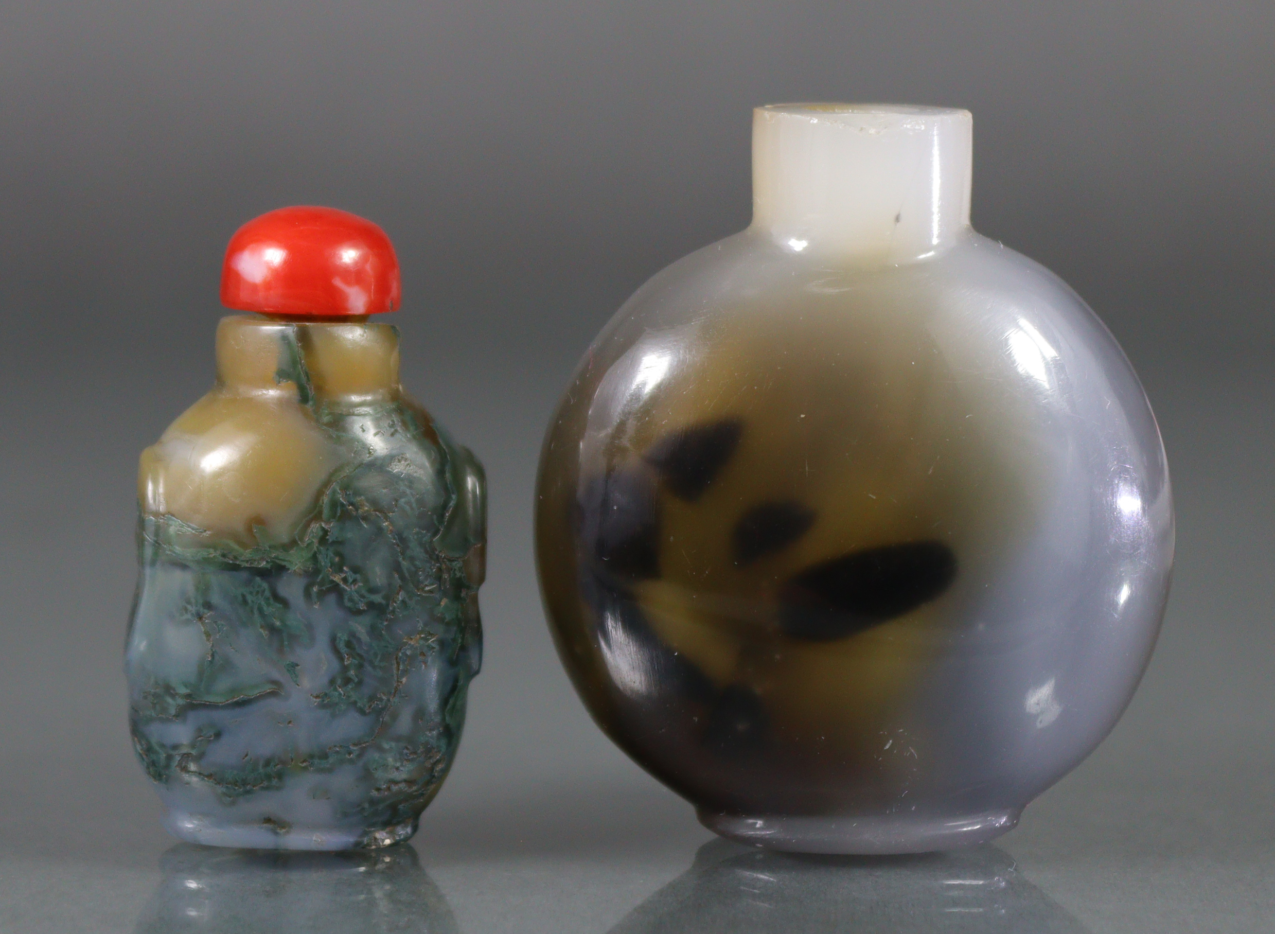 Two Chinese agate snuff bottles, the larger of rounded circular form, with lavender & green