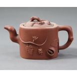 A Chinese Yixing teapot of rounded oblong form with straight sides, moulded decoration of fruiting