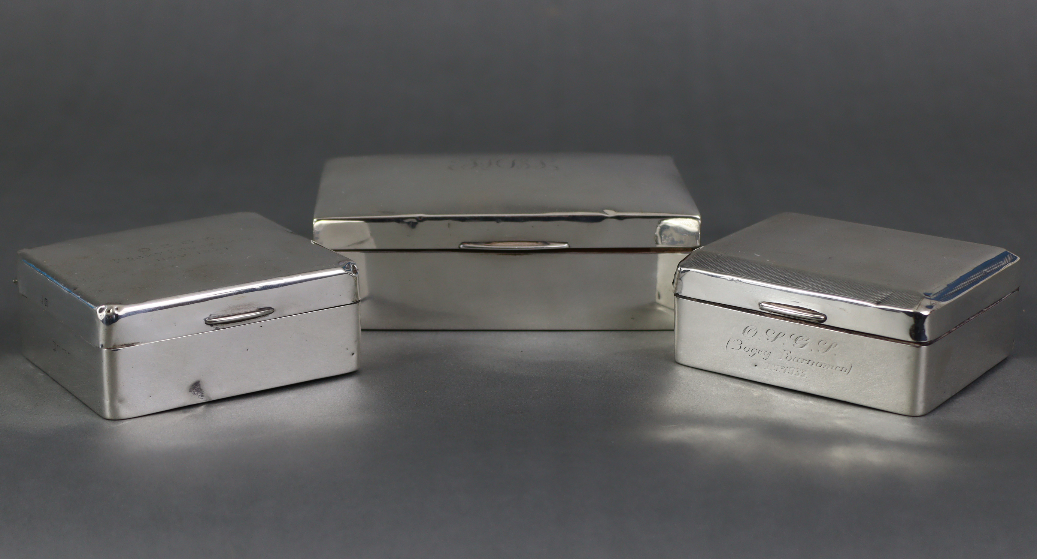 A silver rectangular cigarette box, with engraved initials to the hinged lift lid, Birmingham