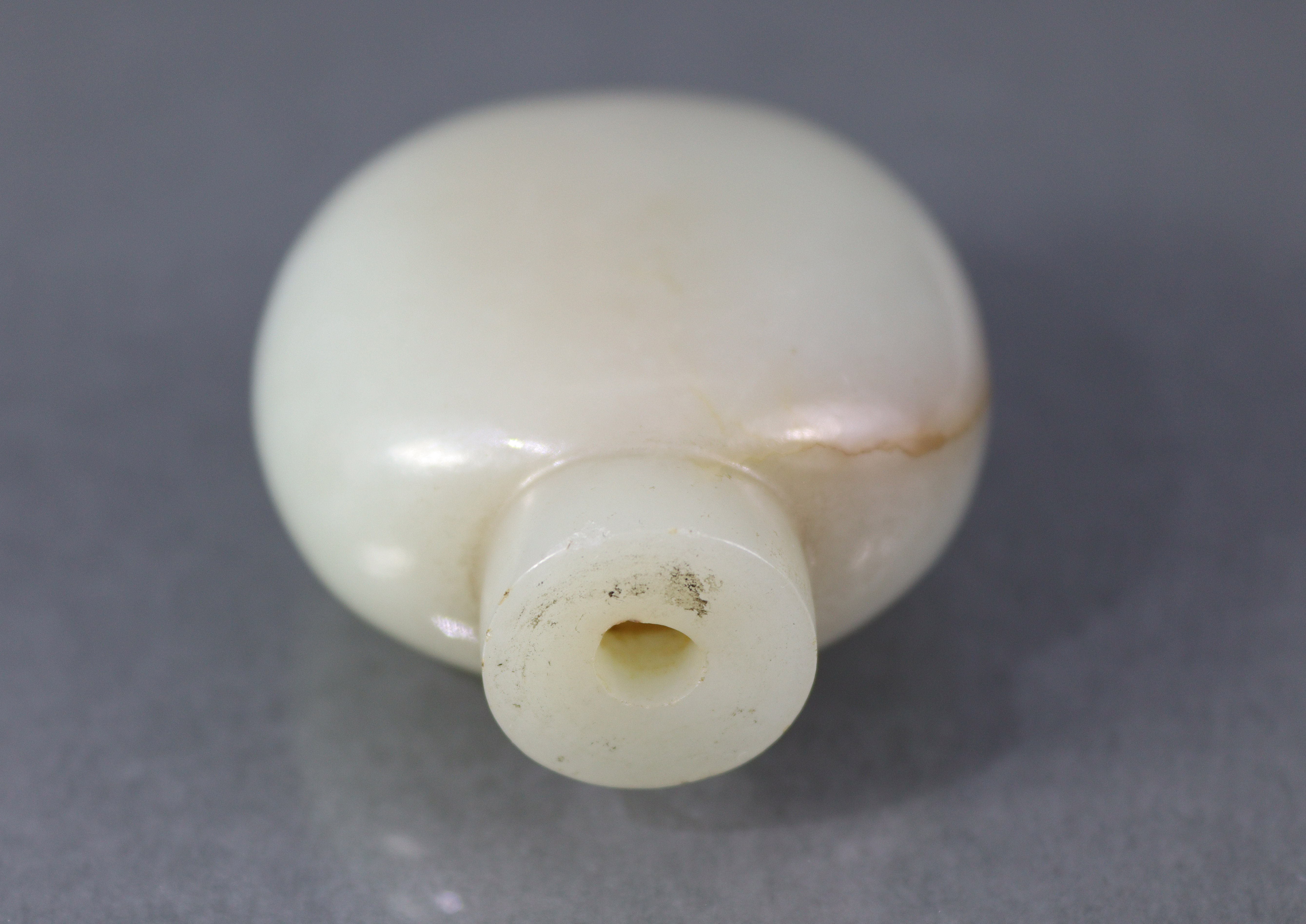 A Chinese pale celadon jade snuff bottle of rounded ovoid form, with russet coloured vein to one - Image 10 of 12