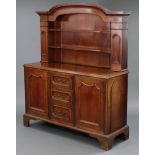 A mahogany low dresser with moulded cornice, fitted two shaped shelves & two narrow cupboards to the