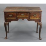 An 18th century oak lowboy with moulded edge to the rectangular top, fitted three frieze drawers
