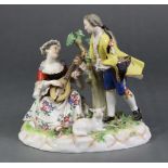 A late 19th century Meissen porcelain romantic figure group of a standing male holding flowers, &