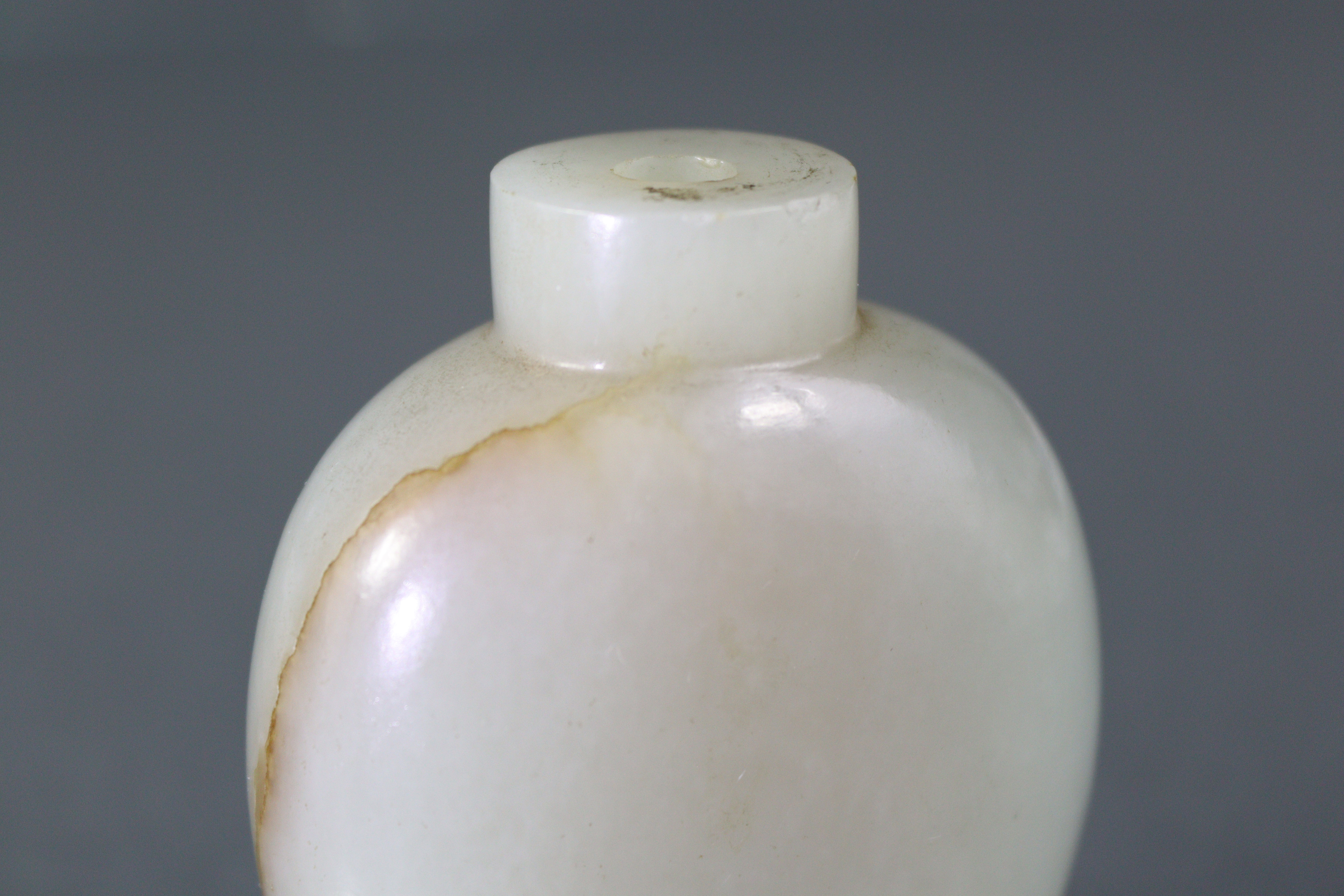 A Chinese pale celadon jade snuff bottle of rounded ovoid form, with russet coloured vein to one - Image 8 of 12