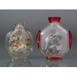 Two Chinese inside-painted snuff bottles, the smaller of clear glass & decorated with Shih Tzu &