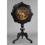 A Victorian japanned papier-mâché tripod table, the circular tilt-top with card-cut rim & painted