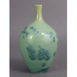 A contemporary studio porcelain bottle vase with narrow neck, celadon glazed with turquoise