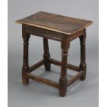 A 17th century oak joint stool, with moulded edge to the rectangular seat, fluted frieze, & on