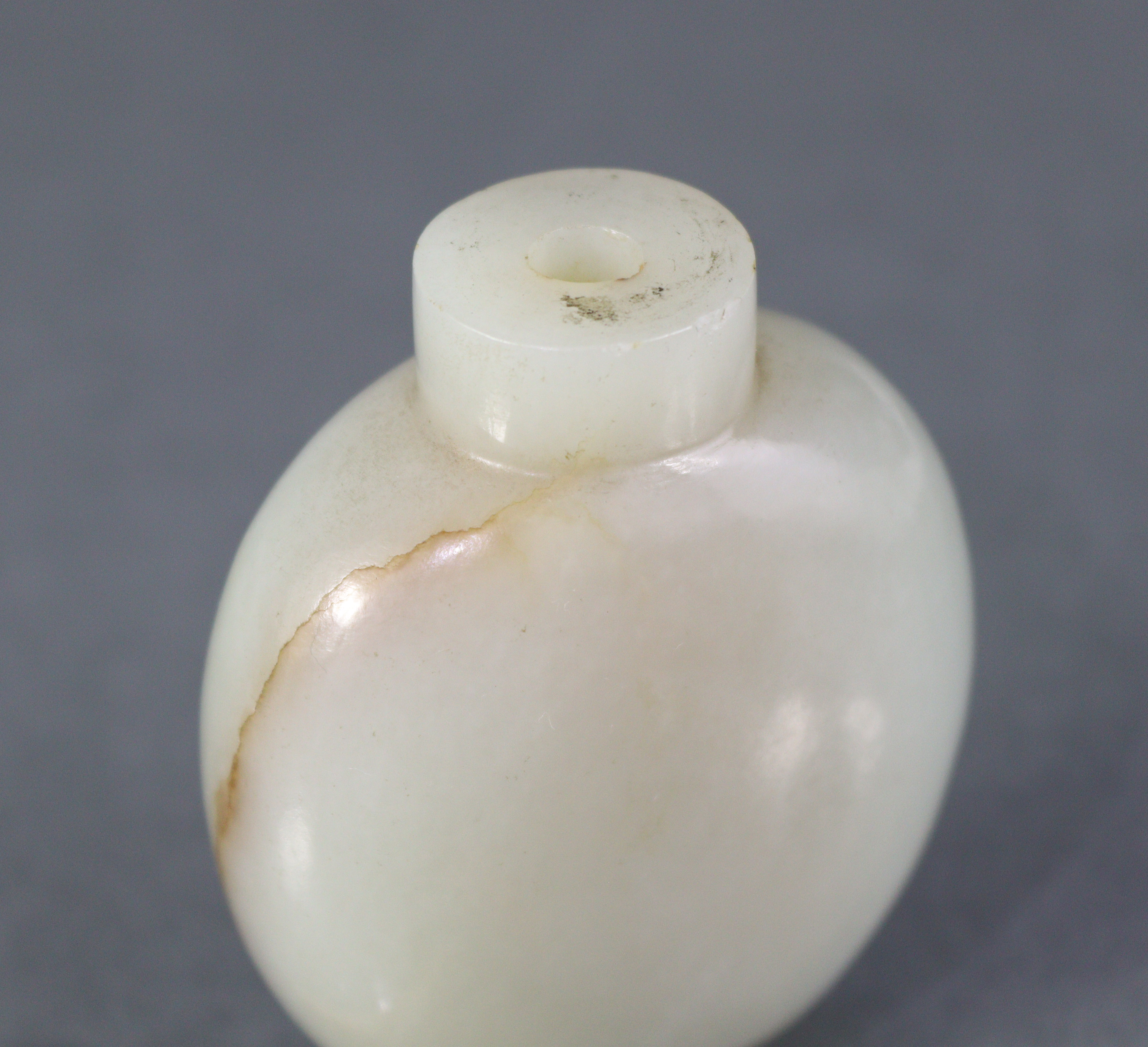 A Chinese pale celadon jade snuff bottle of rounded ovoid form, with russet coloured vein to one - Image 7 of 12