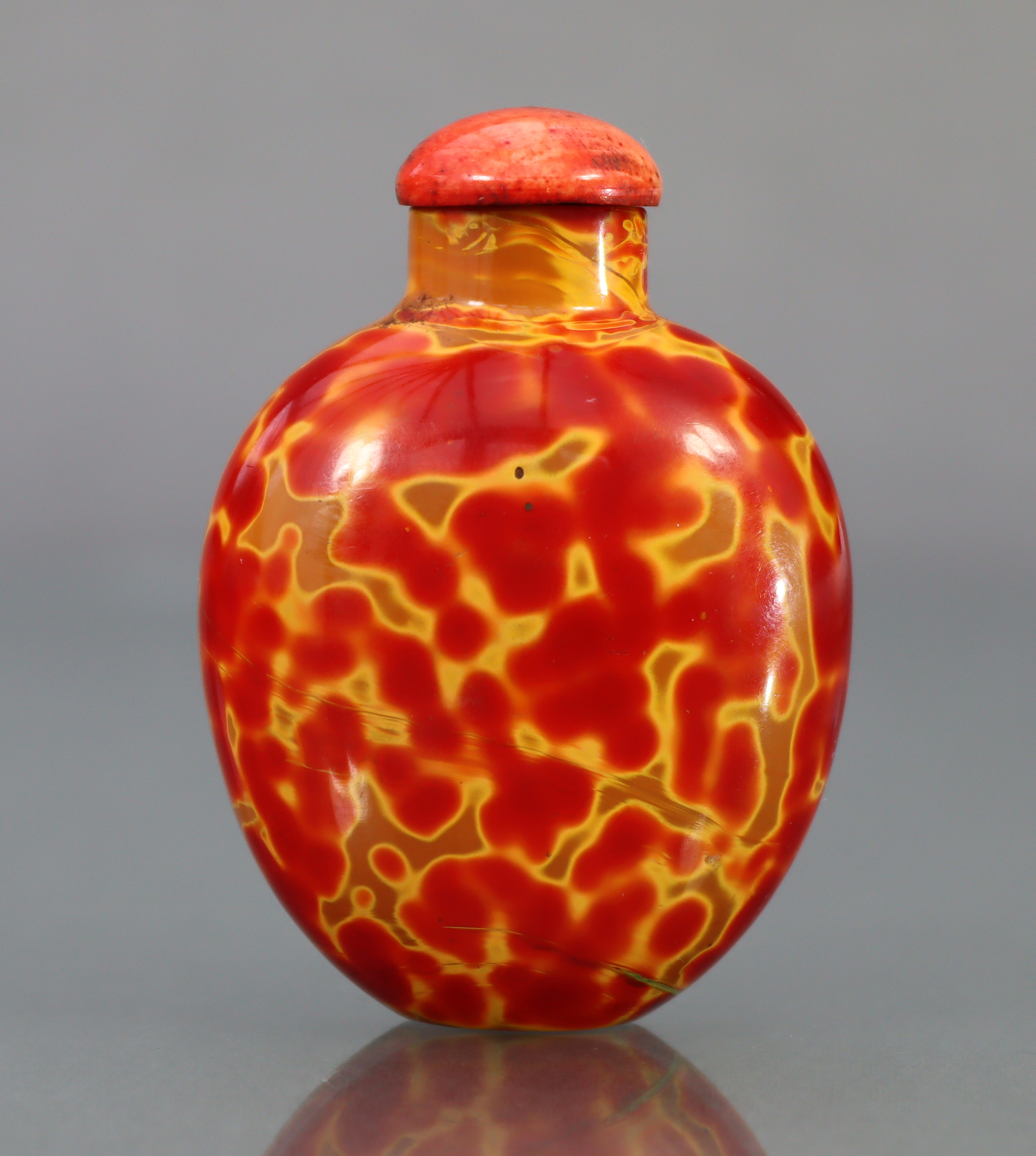 A CHINESE 'REALGAR' GLASS SNUFF BOTTLE, of rounded ovoid form & bright red & yellow colour, 2¼” high