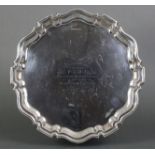 A silver salver with pie-crust edge & three scroll pad feet, inscribed to the centre: