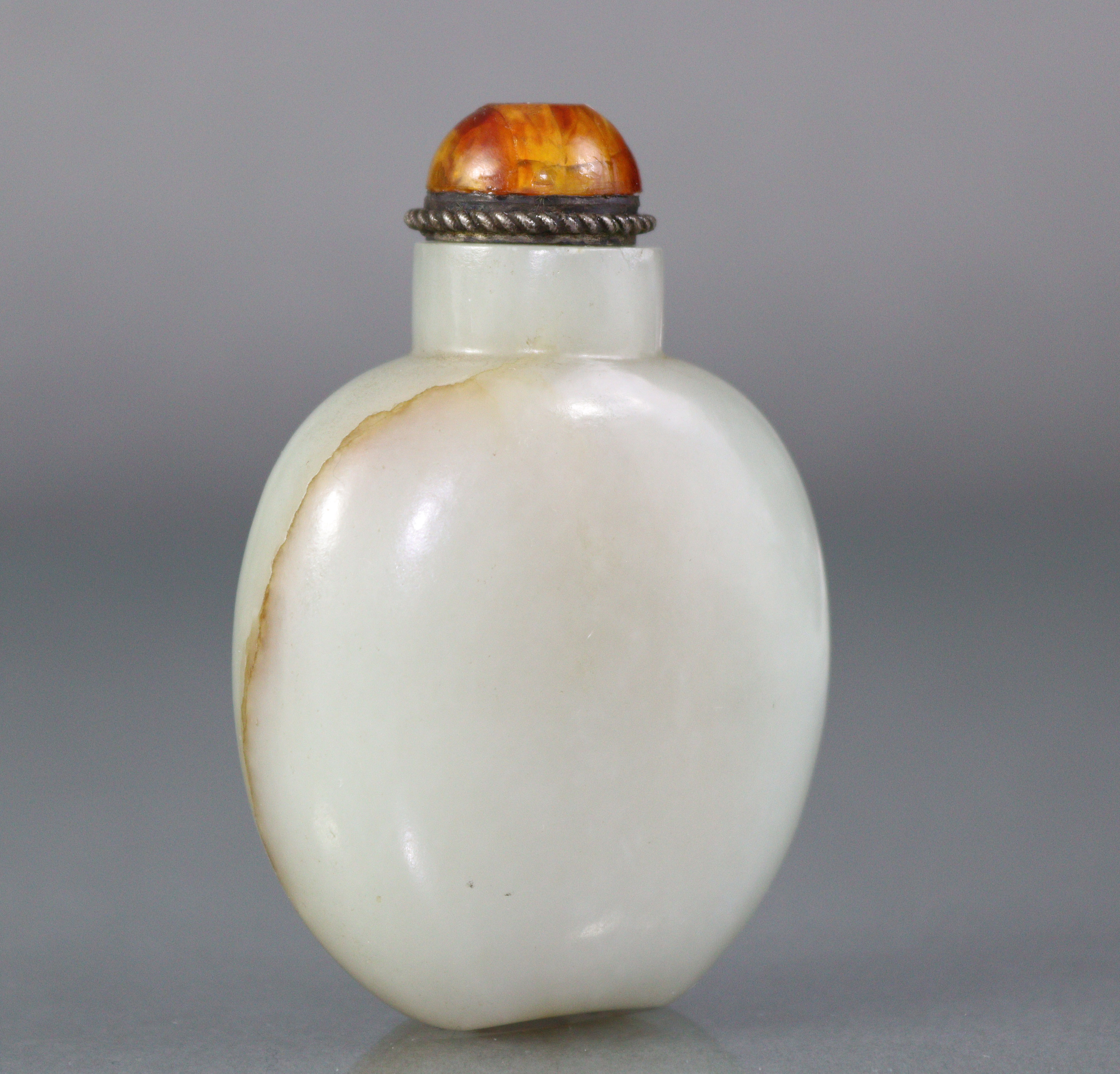 A Chinese pale celadon jade snuff bottle of rounded ovoid form, with russet coloured vein to one - Image 2 of 12