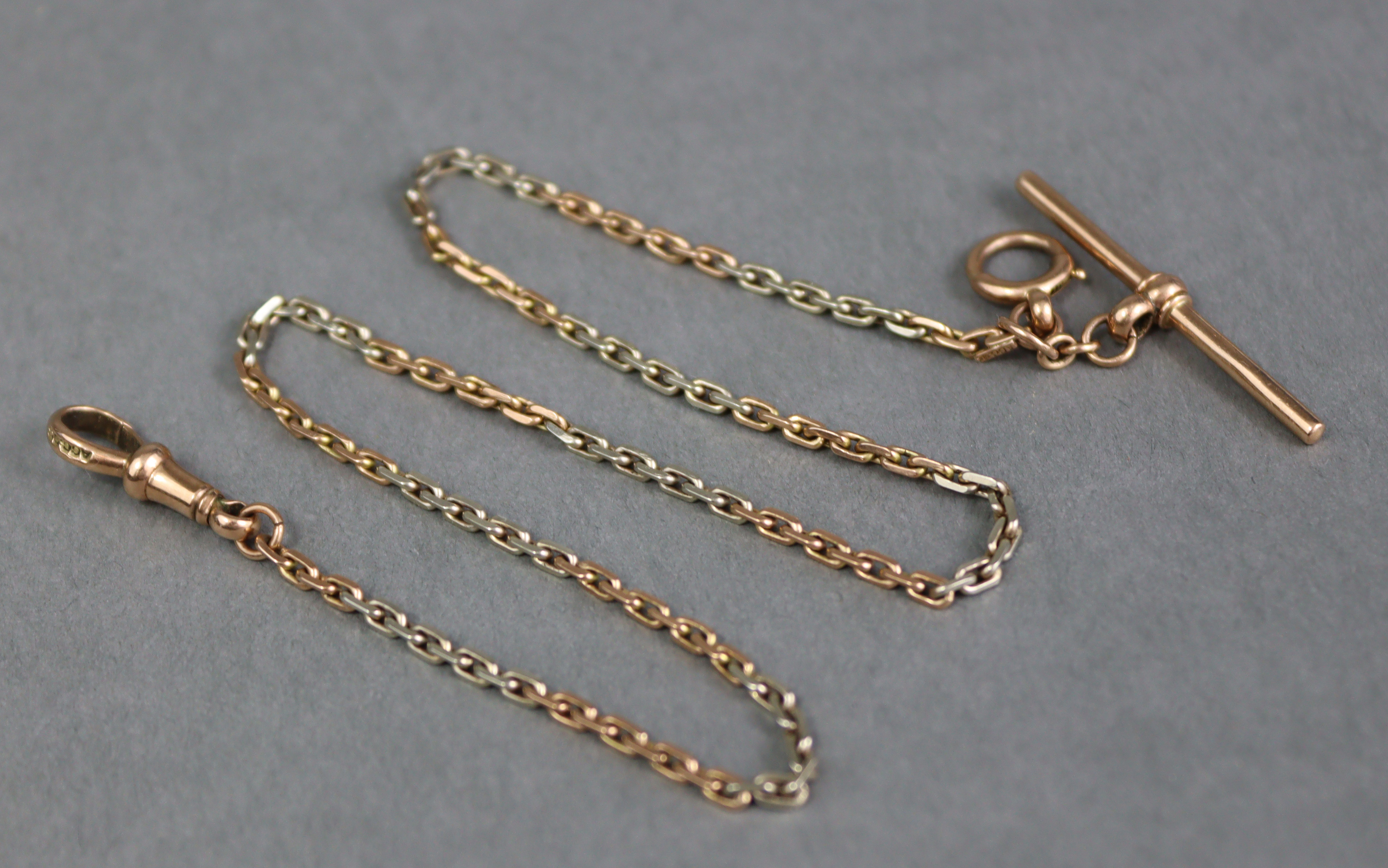 A 9ct. gold albert with alternating length of white & gold oblong links; 13¼” long. (9.4gm).