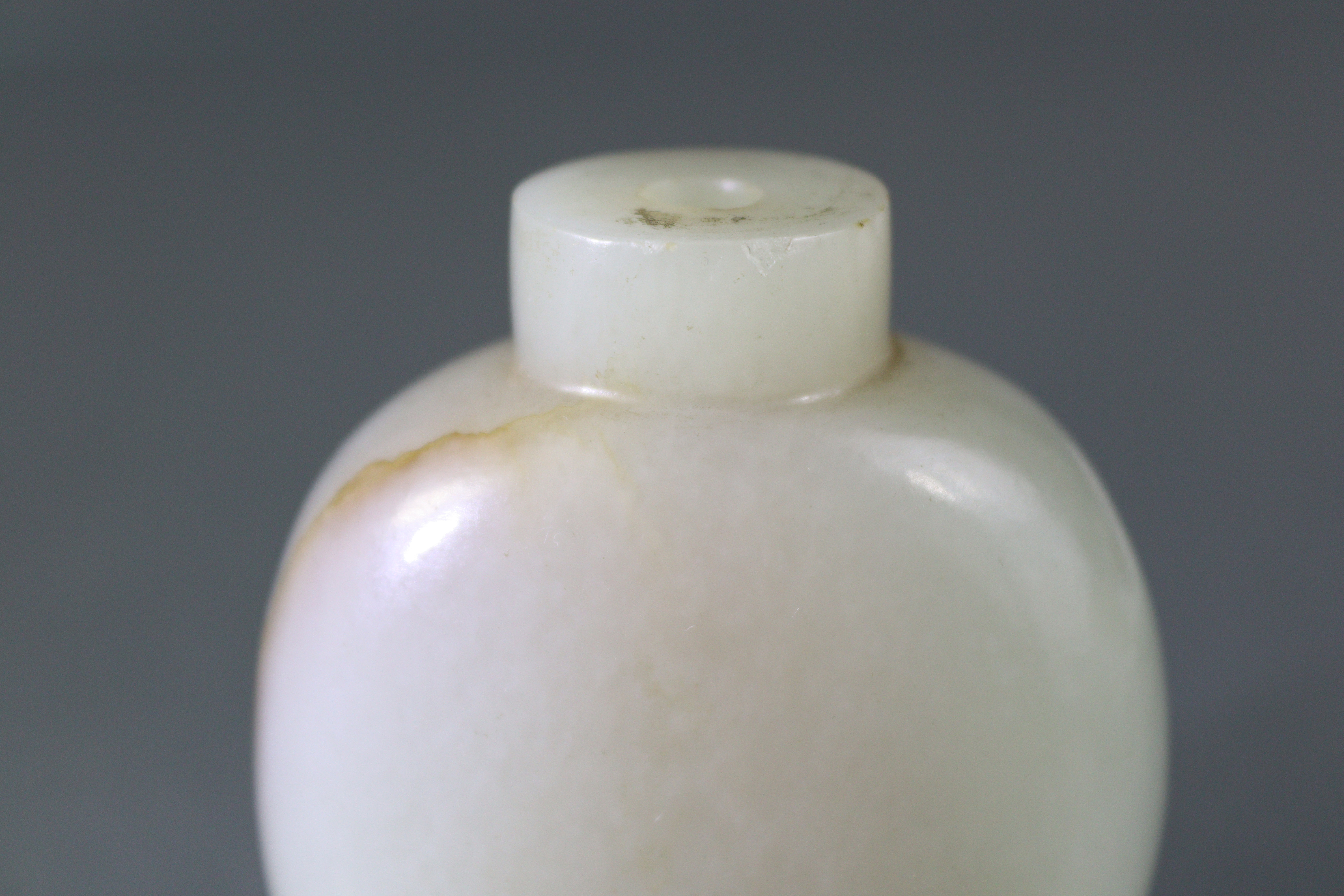 A Chinese pale celadon jade snuff bottle of rounded ovoid form, with russet coloured vein to one - Image 9 of 12