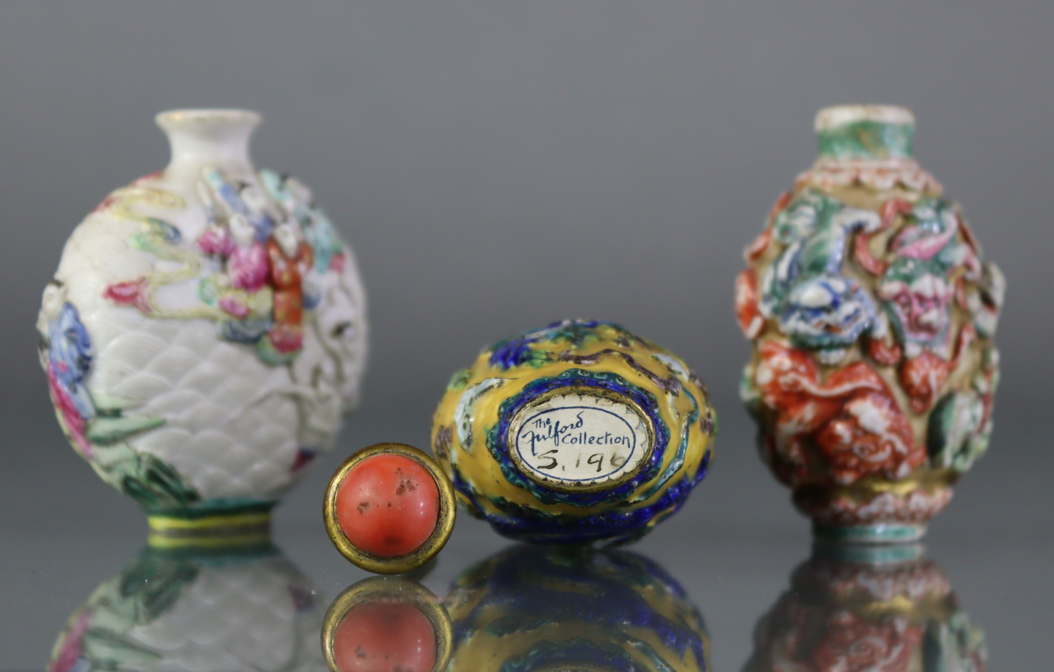 Three Chinese moulded porcelain snuff bottles, the largest decorated with a dragon & phoenix in - Image 4 of 5
