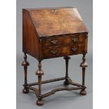 A William & Mary style walnut small bureau with fitted interior enclosed by a fall-front above two