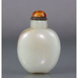 A Chinese pale celadon jade snuff bottle of rounded ovoid form, with russet coloured vein to one