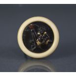 A Japanese Kagamibuta netsuke, the circular mixed metal plaque depicting Ashimaga; the bowl of plain