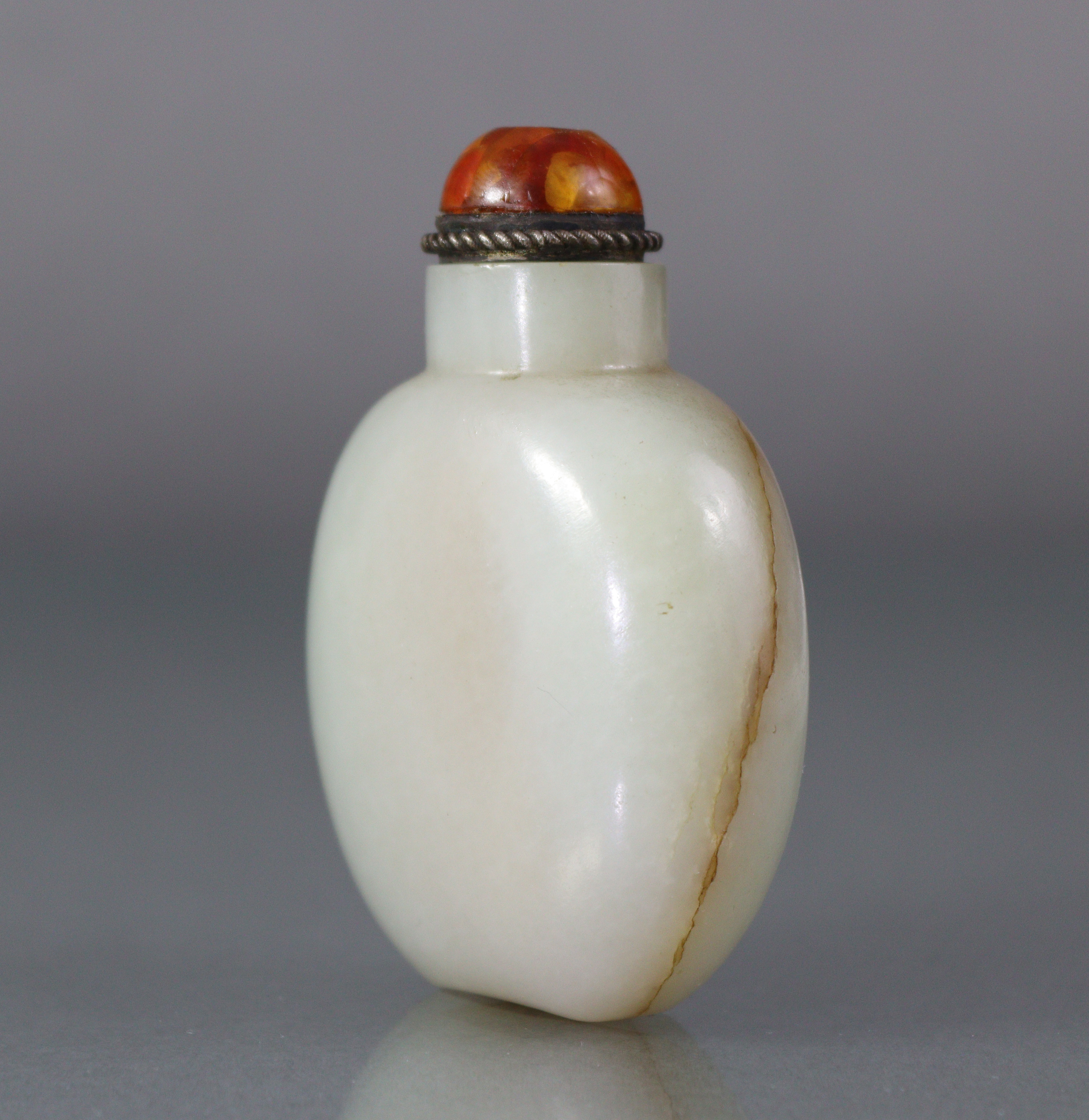 A Chinese pale celadon jade snuff bottle of rounded ovoid form, with russet coloured vein to one - Image 3 of 12