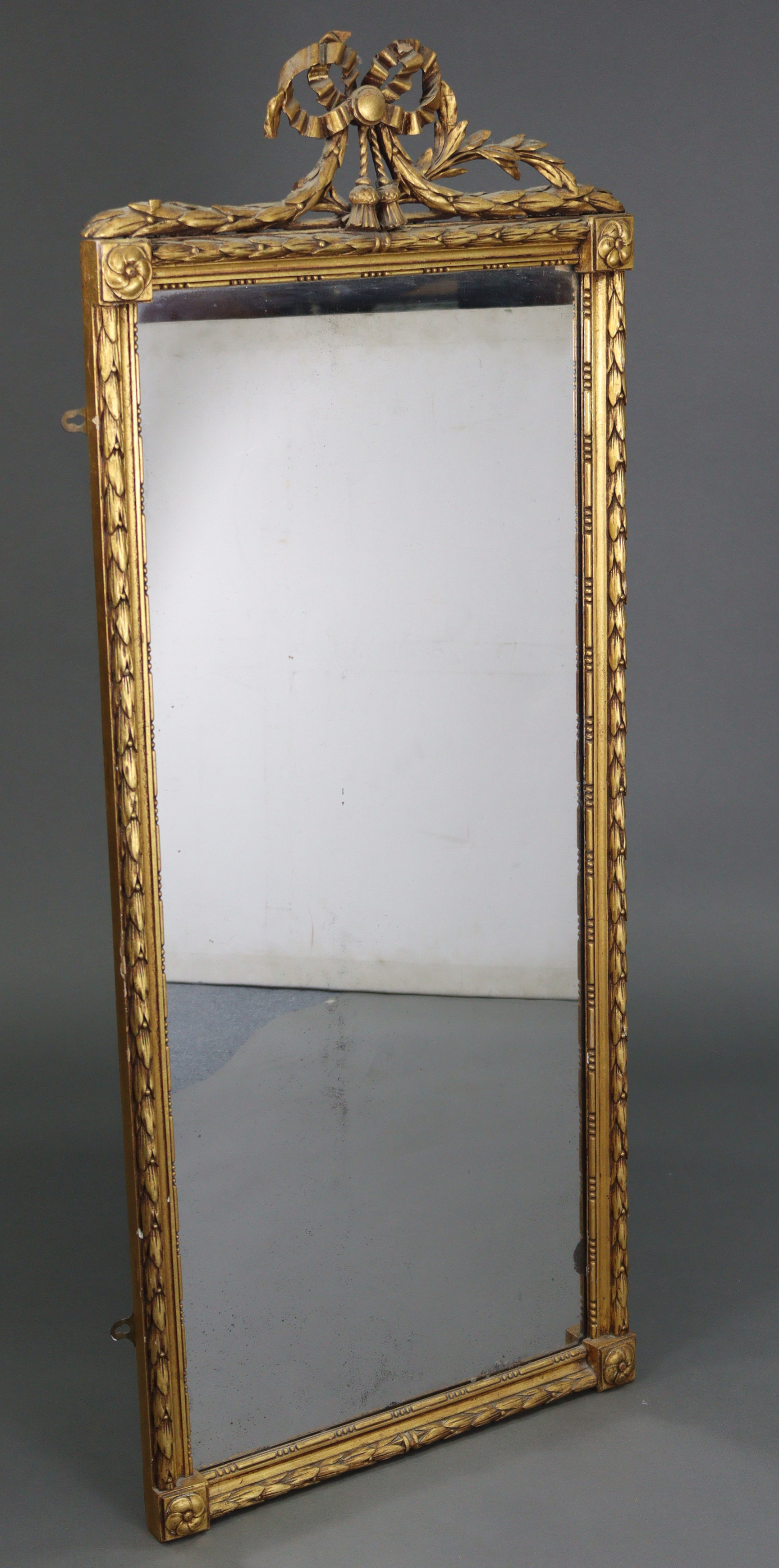 A late 19th/early 20th century gilt frame rectangular wall mirror with carved giltwood ribbon-bow