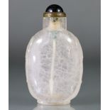 A Chinese carved crystal snuff bottle of rounded ovoid form, with mask-&-ring handles to each