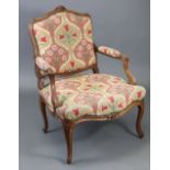 A Louis XV beechwood fauteuil by Michel Cresson, with fluted foliate-carved frame, cartouche