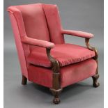 A late 19th/early 20th century armchair, with padded seat, back & open arms upholstered rose pink