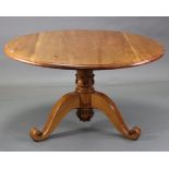 A pine circular tilt-top pedestal dining table, on carved & turned centre column & three cabriole