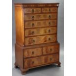 A reproduction walnut small chest-on-chest, the upper part fitted two short & four long graduated