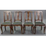 A set of four Queen Anne-style dining chairs with shaped splat back, padded seats, & on slender