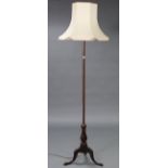 A mahogany standard lamp with vase-turned centre column & on three cabriole legs, with shade.
