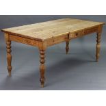 A pine farmhouse table with rectangular top, fitted centre frieze drawer to one side, & on four
