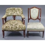 A late Victorian tub-shaped chair with padded seat, back & arms upholstered green & white floral