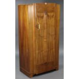 A mid-20th century walnut-finish gent’s wardrobe with fitted interior enclosed by centre panel door,