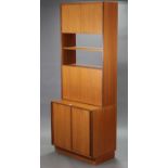 A G-Plan teak tall wall unit the upper part enclosed by pair of panel doors to the top above an open