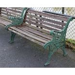 A Victorian-style garden bench with teak slatted seat & back, & on green painted cast-metal end