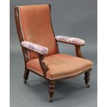 A late 19th/early 20th century beech-frame armchair with padded seat, back, & open arms, & on